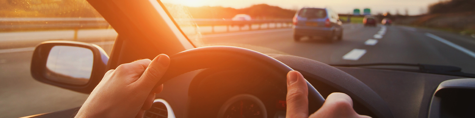 hands of car driver on steering wheel, road trip, driving on highway road