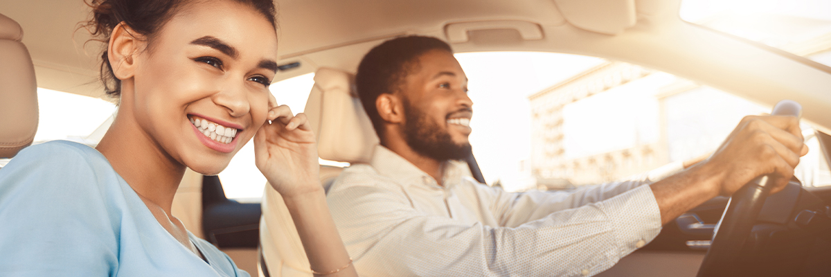 Happy couple driving car