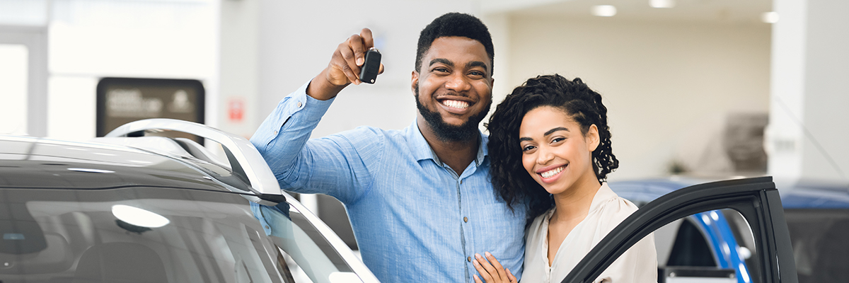 happy couple with car keys