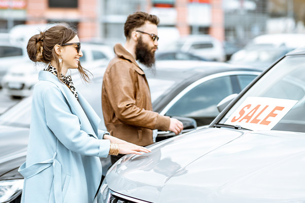 Couple buying used car from a dealership