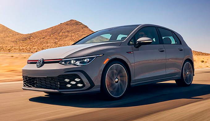 Golf GTI shown in Moonstone Gray driving out of foothills into desert landscape.