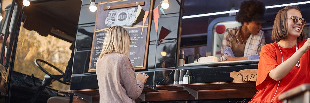 people ordering and eating at a food truck