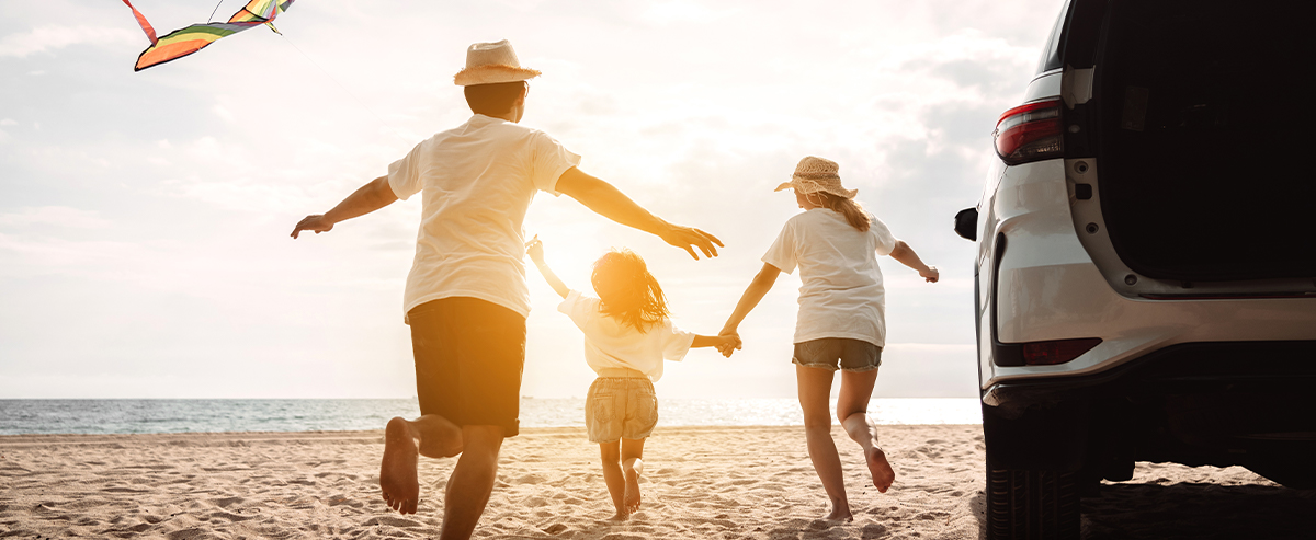 family playing on beach