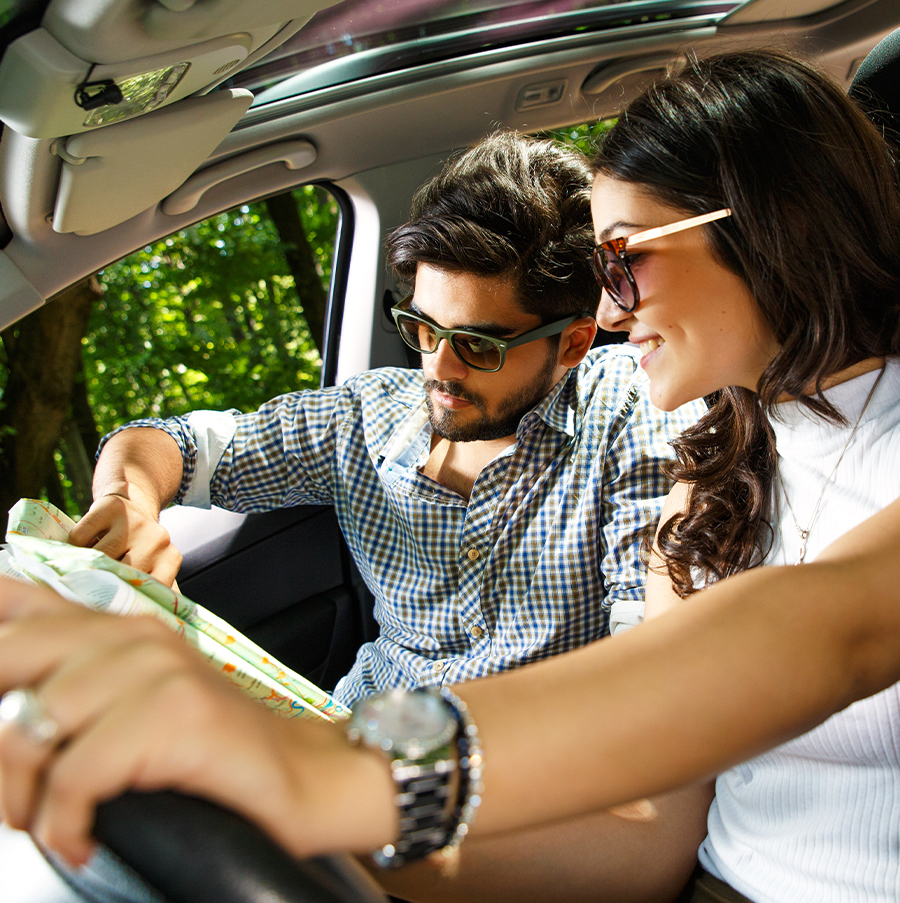 couple reads map in car