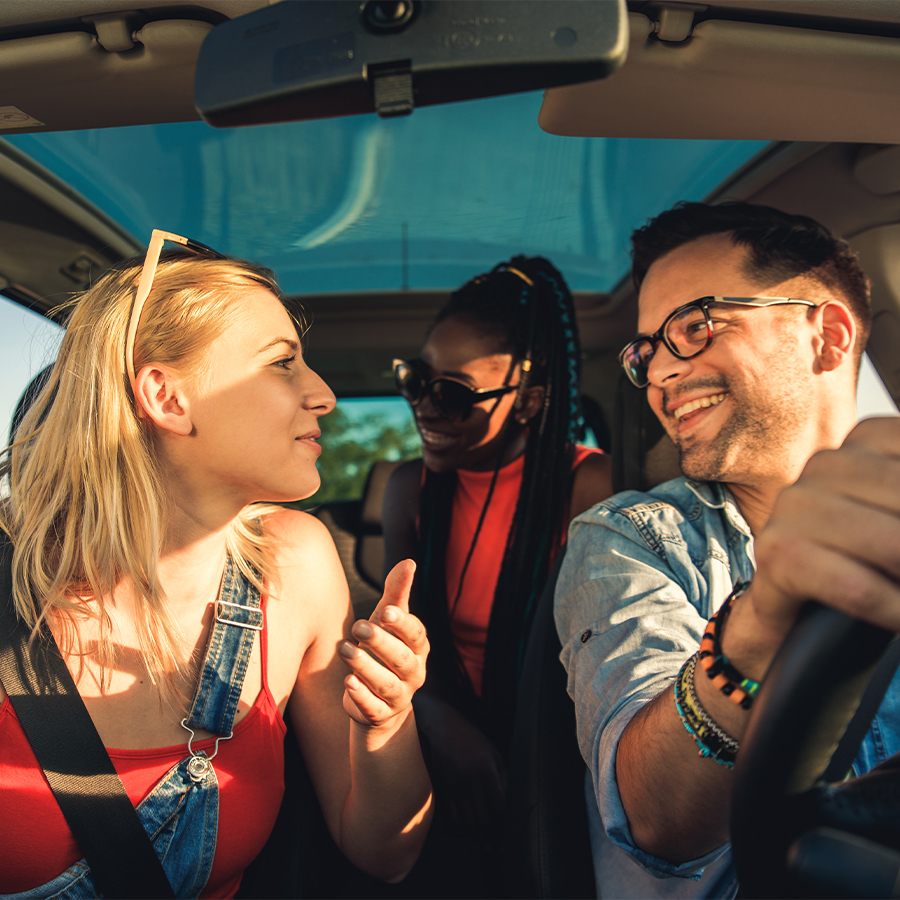 happy group of friends in a car