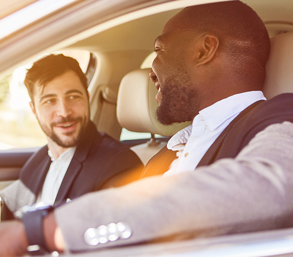 Two people sitting in a car having a good conversation