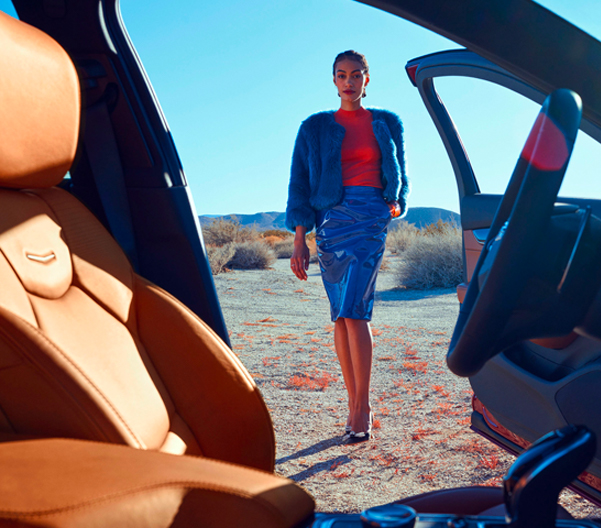 woman walking towards a cadillac