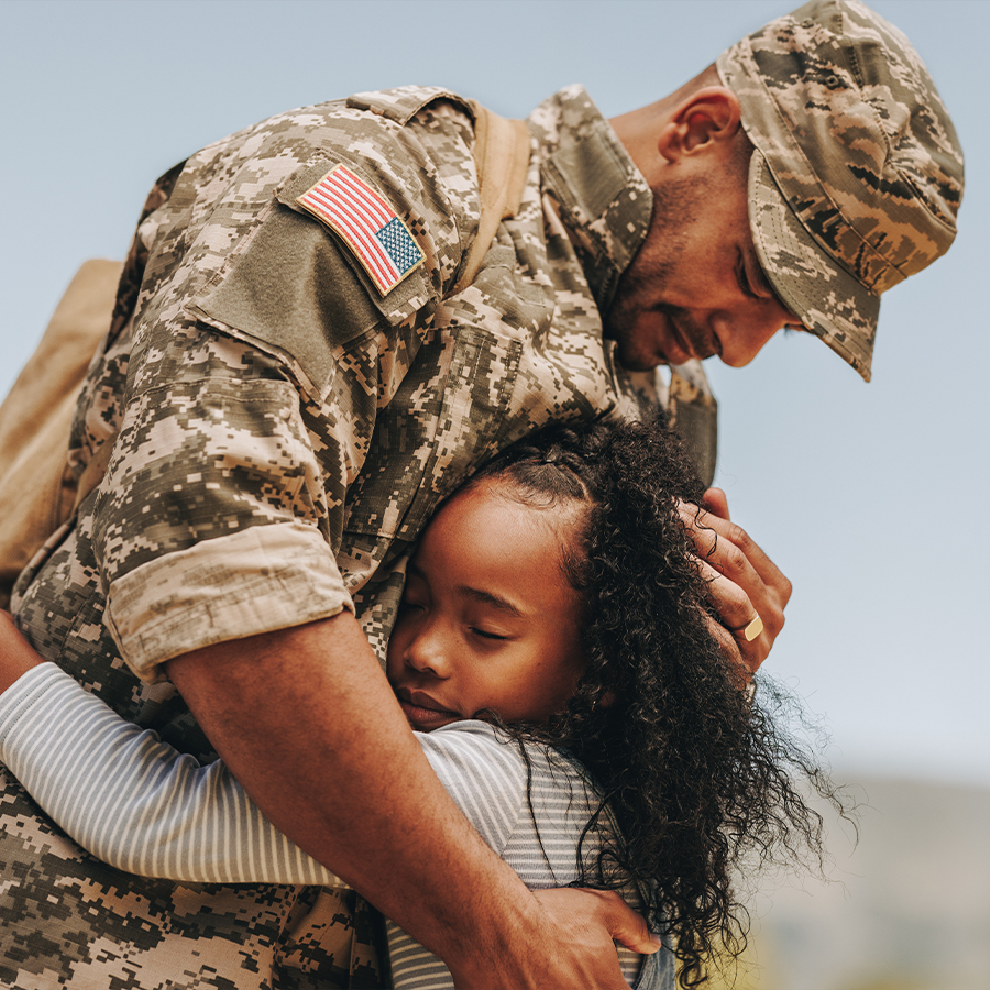 Military Man hugging his daughter