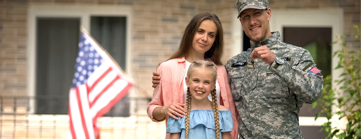 Military family standing together with car key