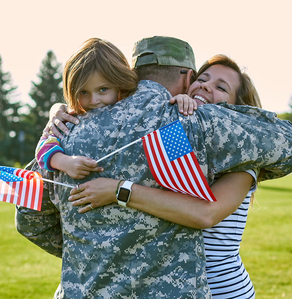 Soldier being hugged by family