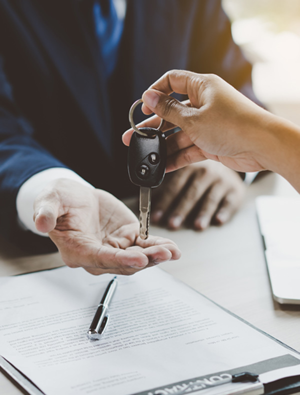 close up of car keys being handed over