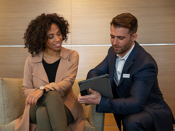 Person on their computer in the dealership with a calculator beside it