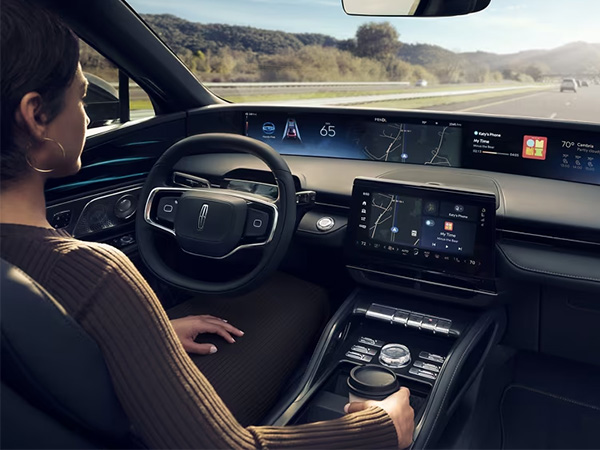 Dealership employee pointing to finance paperwork