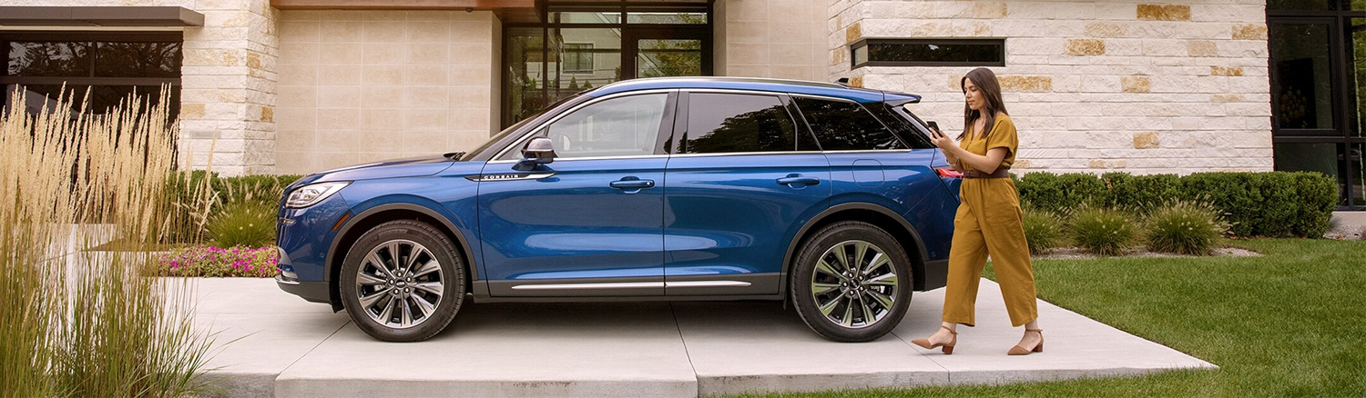Dealership employee showing a couple a vehicle in the showroom