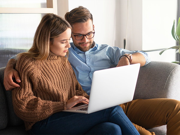 Person on their computer in the dealership with a calculator beside it