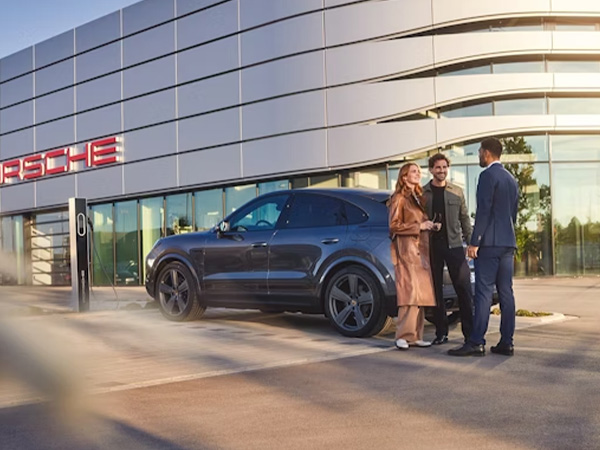 Dealership employee pointing to finance paperwork