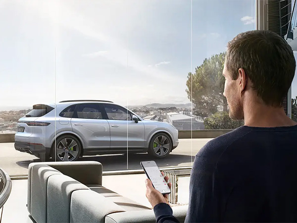 Person on their computer in the dealership with a calculator beside it