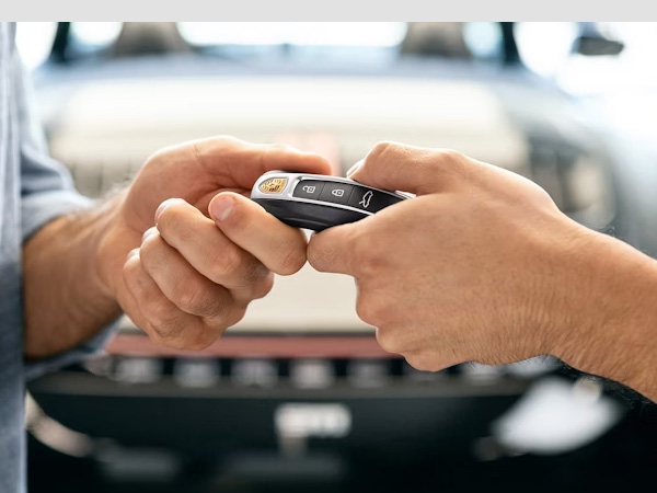 Close up of a person holding keys over a customers hand