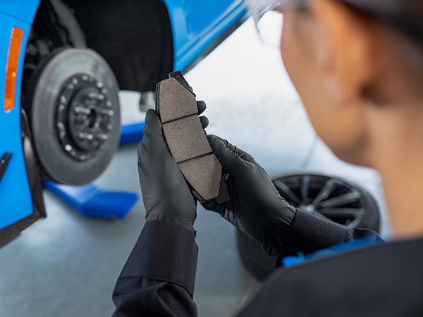 Close up of hands holding brake pads