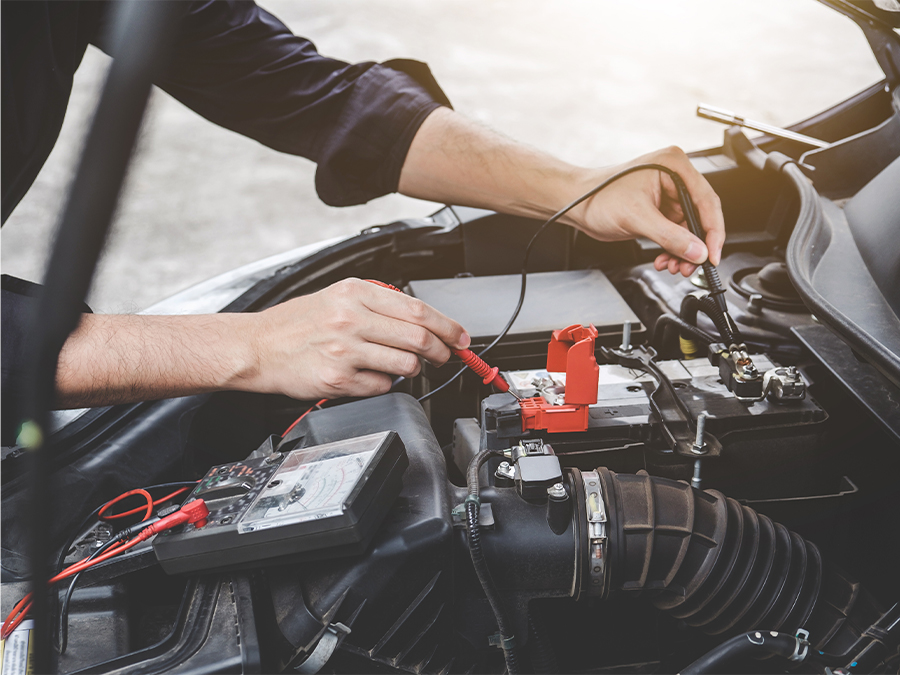 Service tech testing a battery