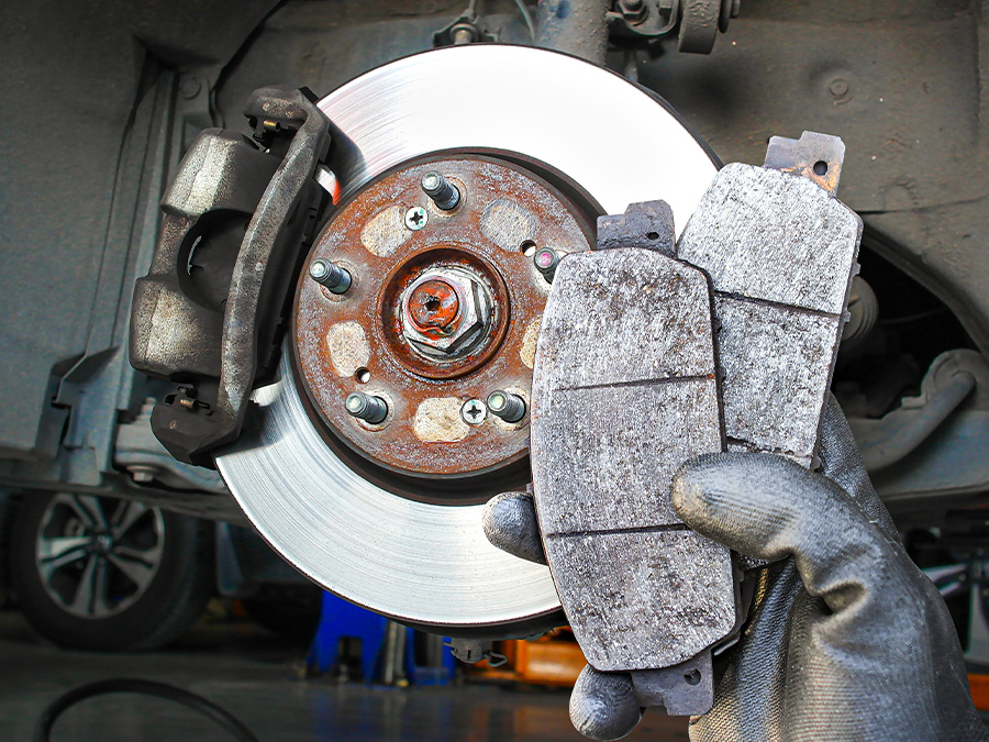 Close up of hands holding brake pads
