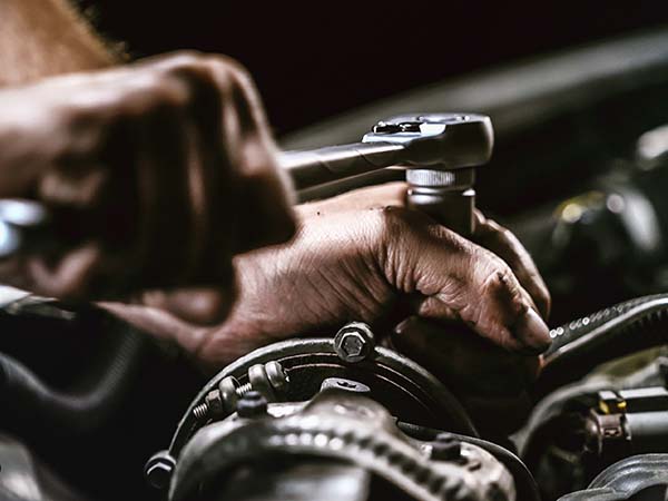 Service tech working on an engine