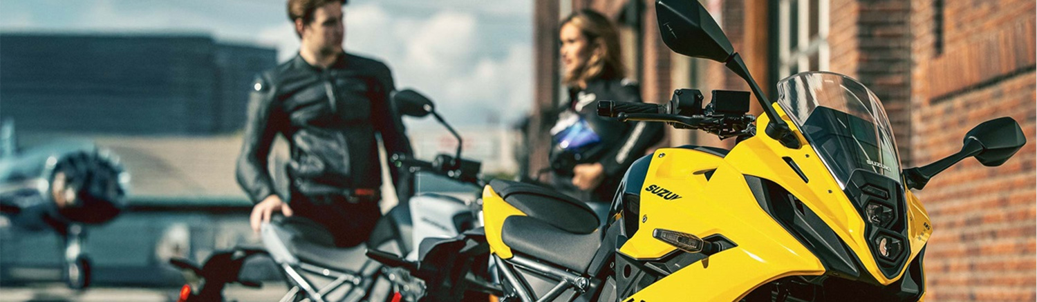Close up of motorcycle with a couple behind it 
