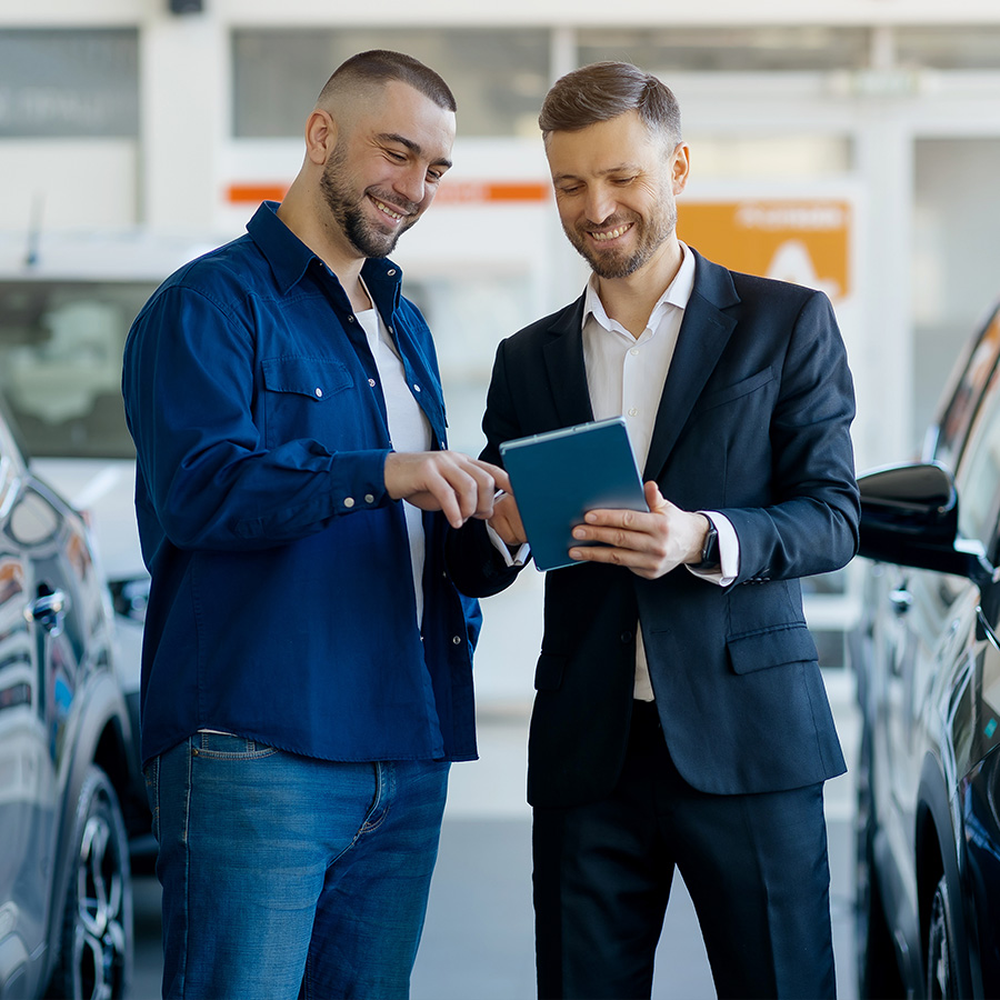 Salesman showing digital tablet to a male customer