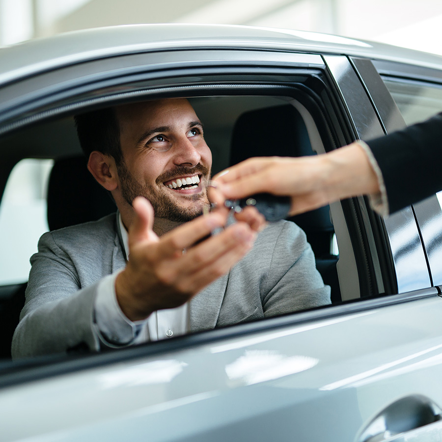 Happy customer being handed keys to their vehicle