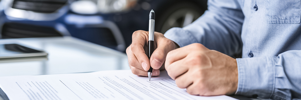 Up close shot of someone signing documents