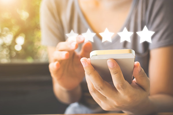 Graphic of someone leaving 5 star review on smartphone