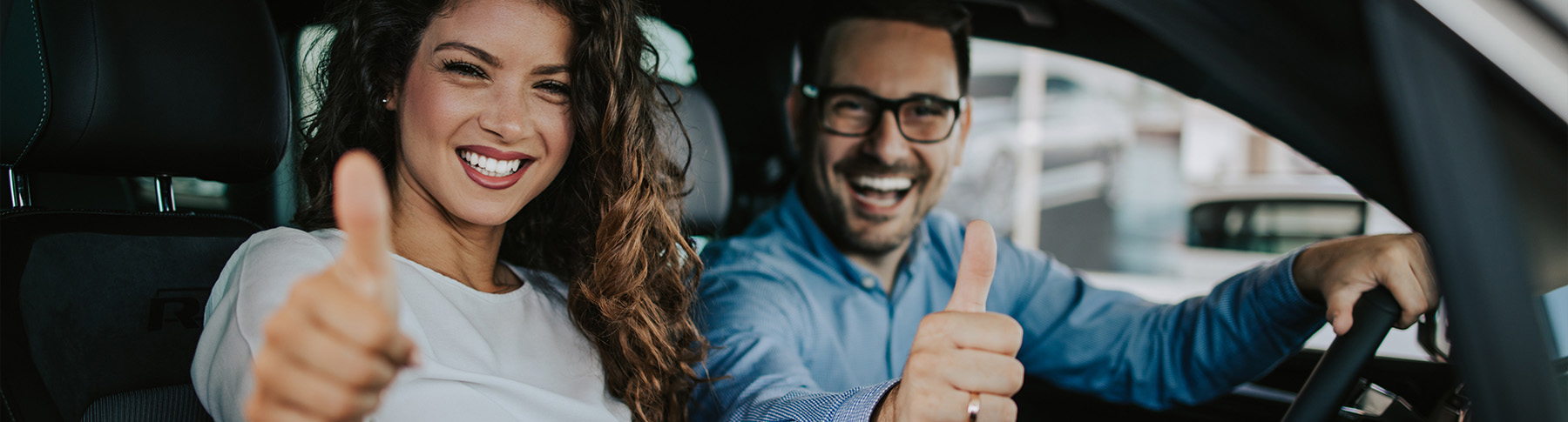 happy couple buying new car
