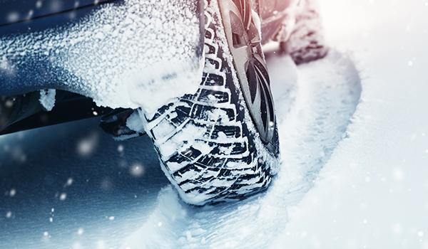 Close up of a tire on a car in the snow