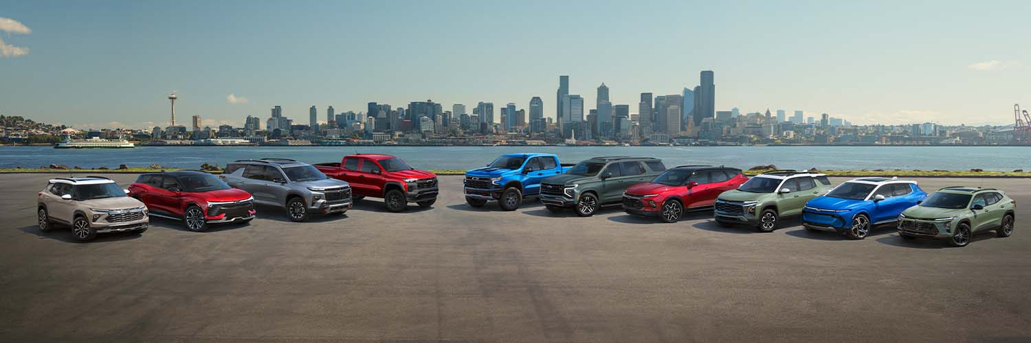 Lineup of all 2026 Chevy Models with a city in the background