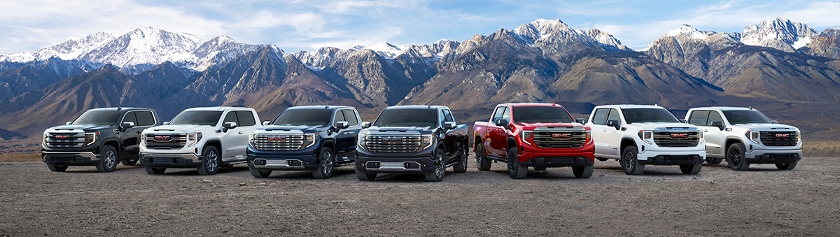 Lineup of all GMC Sierra Models with mountains in the background