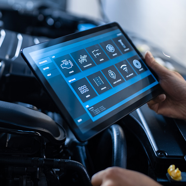 Car Service Manager or Mechanic Uses a Tablet Computer with a Futuristic Interactive Diagnostics Software. Specialist Inspecting the Vehicle in Order to Find Broken Components In the Engine Bay.