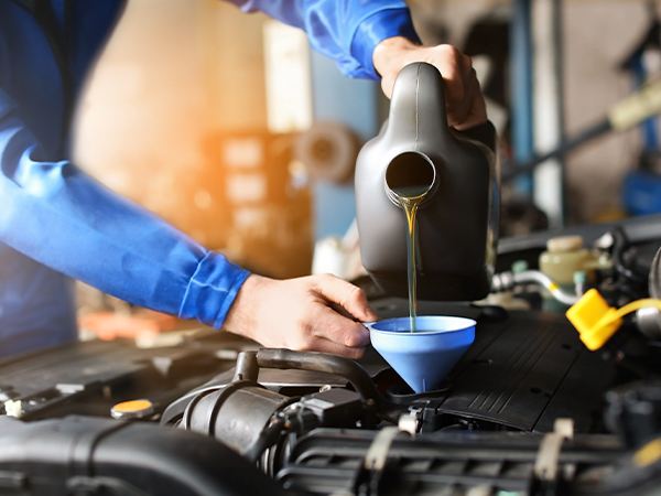 Oil being changed by technician.