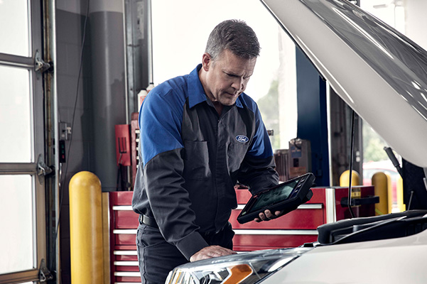 Ford mechanic inspecting battery