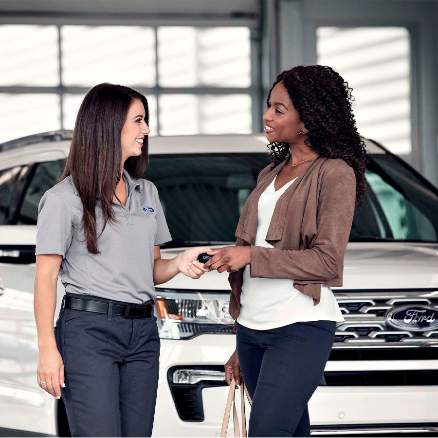 Ford service technician with customer