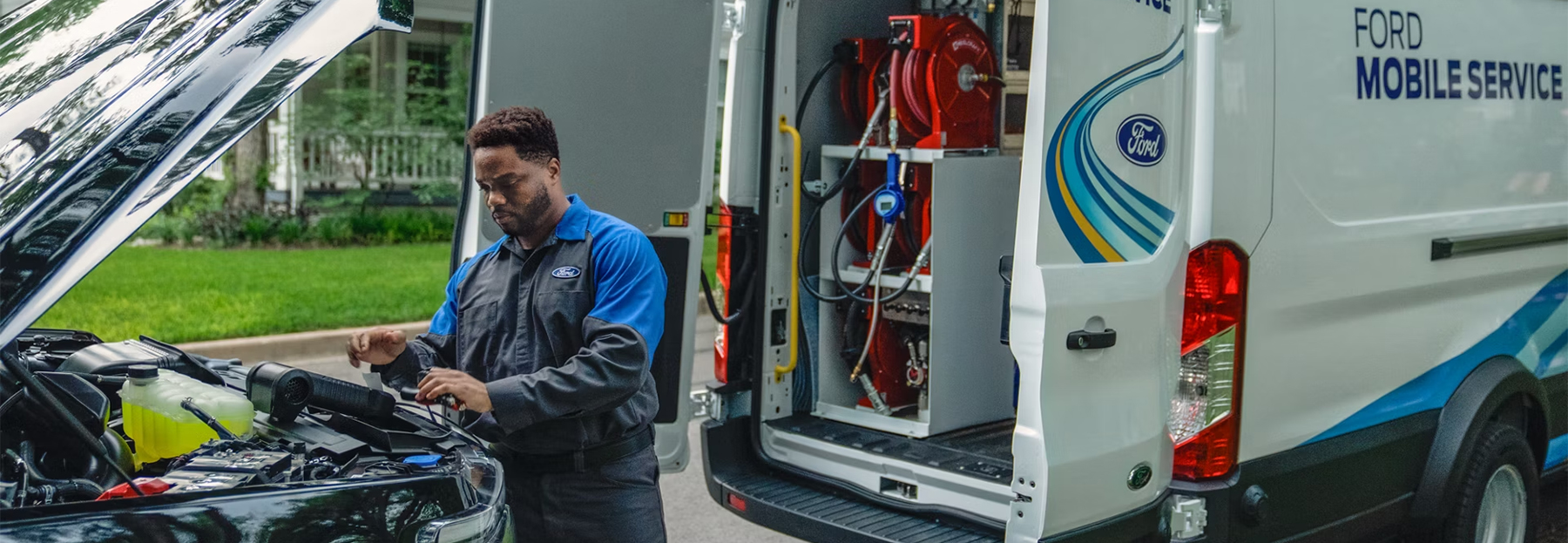 Ford Service PRO working under the hood of a car