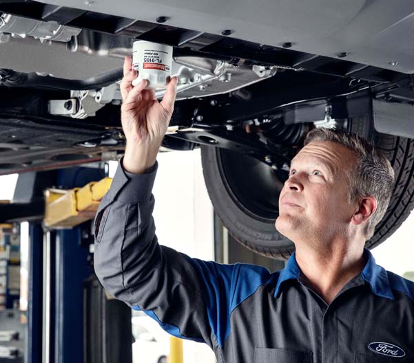 Ford mechanic changing oil filter