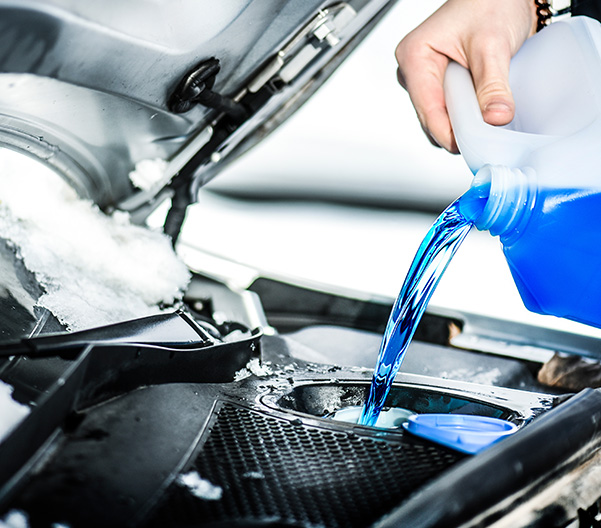 Pouring antifreeze. Antifreeze liquid for washing car screen.