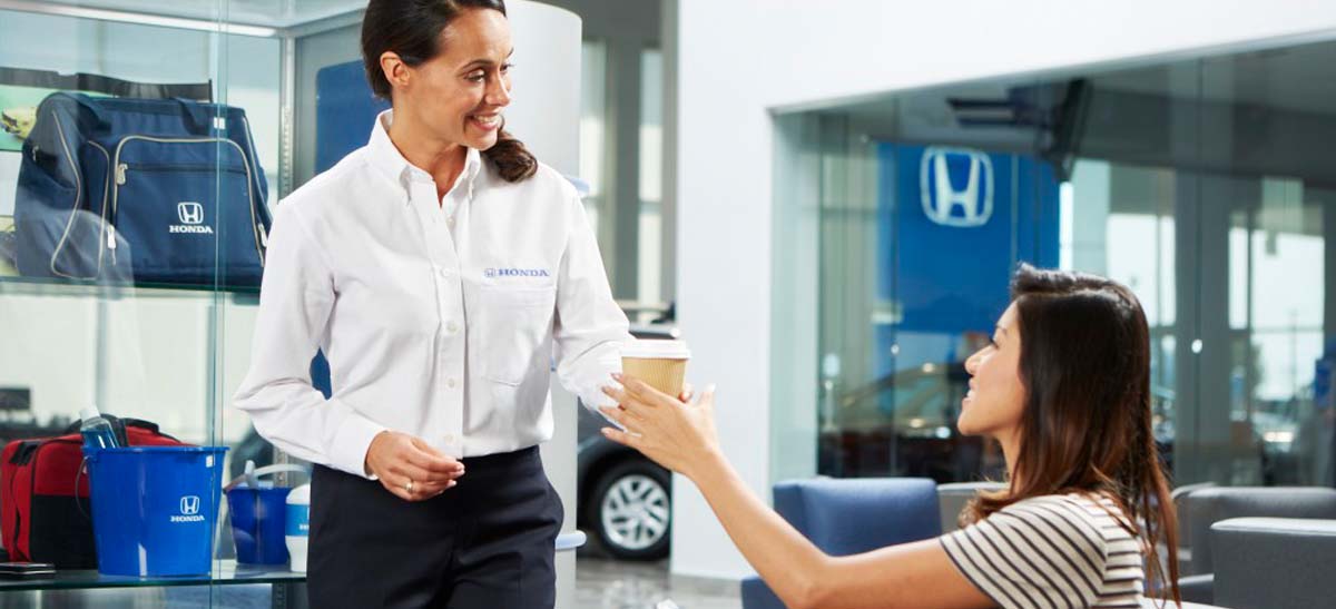 Honda tech grabbing a cup of coffee for a customer in the waiting room