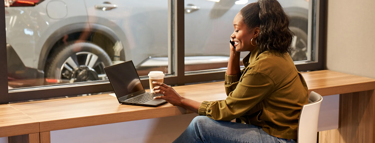 customer sitting at a Nissan dealership while her car is being serviced