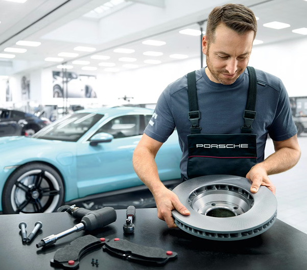 man working with porsche parts