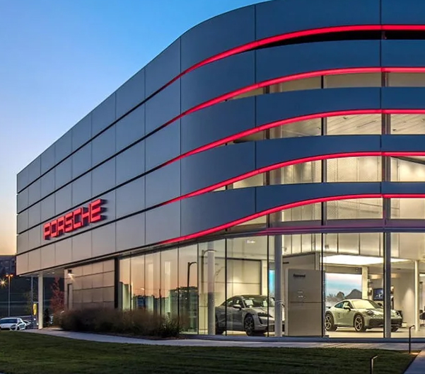A picture of a Porsche Center at dusk