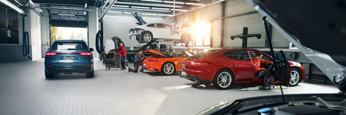 Row of Porsches in mechanic shop