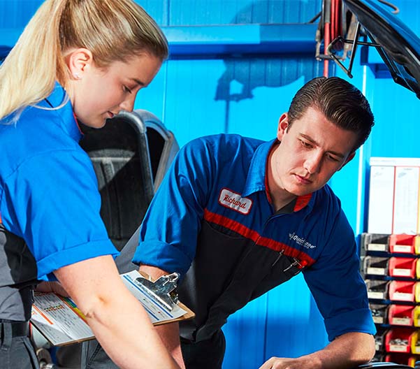 Quick Lane technicians inspecting a vehicle