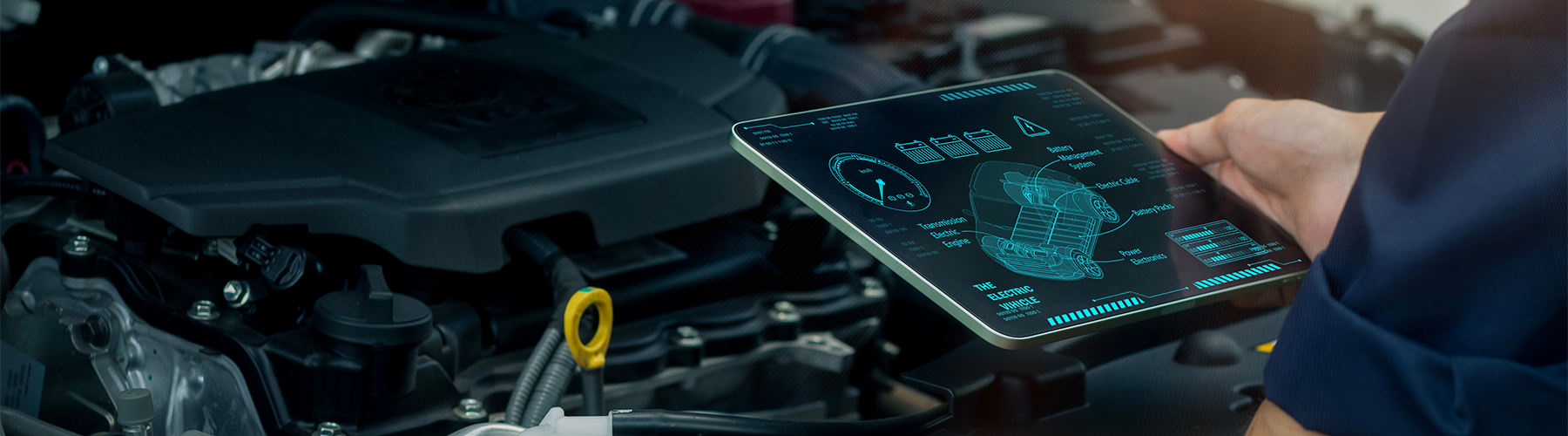 A technician uses a digital tablet to analyze engine data and monitor automotive performance with advanced diagnostic technology.