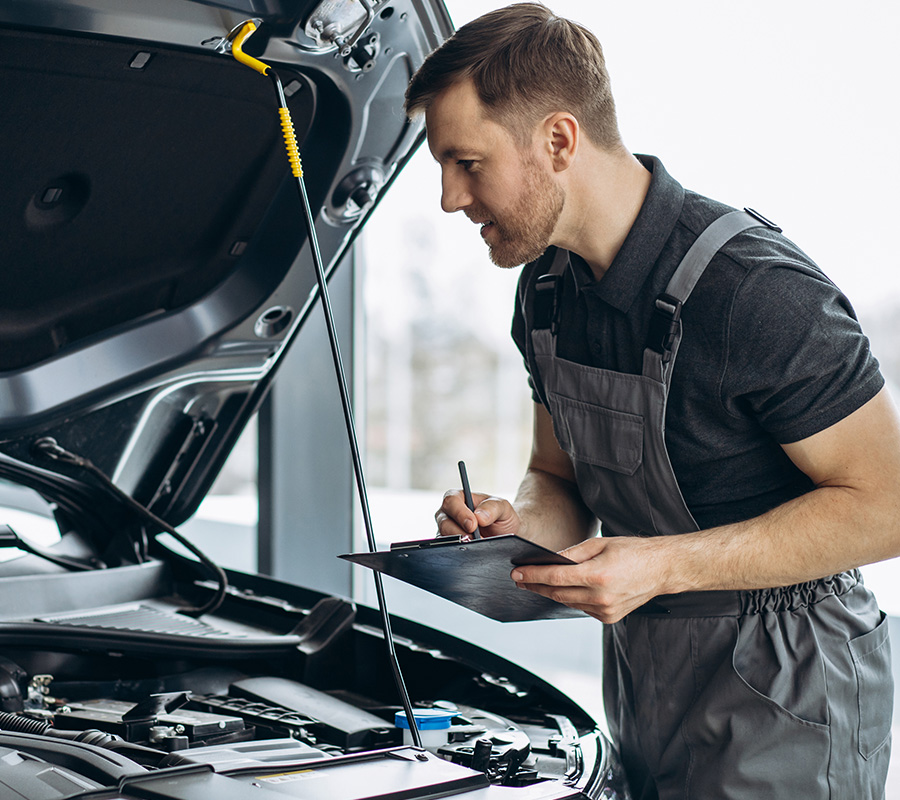 Car mechanic at car service checking up the car